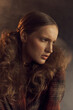 © monchak - portrait photo of a girl with brown curly tails in a vintage checkered jacket, she mysteriously looks away