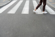 Female Feet Crossing The Crosswalk