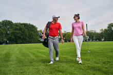 Trainer Looking At A Pleased Female Golfer