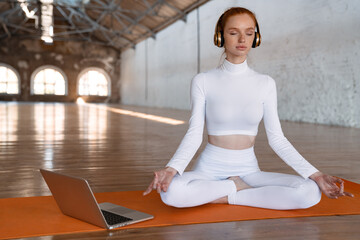 Wall Mural - Healthy young woman doing yoga exercises