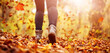 Woman walking outdoors in nature on fallen leaves cover