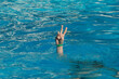 © ausra - Hand coming out of the water, victory gesture
