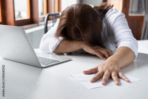 exhausted middle aged woman getting fed up with expensive bill, debt invoice, eviction notice; concept of high cost of living, expensive bill, economic recession, no job no money