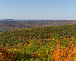 Colorful Autumn vistas of mountains and valleys. Yellow, orange and red leaves glisten in the sunshine- 3