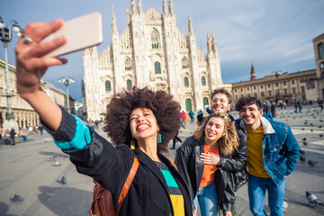 Group of friends tourist taking selfie in front of Milan cathedral