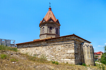 Wall Mural - Armenian church of Saint George, Feodosia, Crimea. Ground level is higher than one of its sides, so it seems to be church is growing up from hill