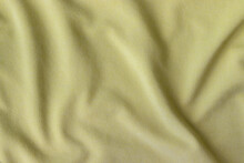 Jersey Cotton Fabric Texture. Crumpled Yellow Textile Background