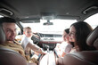 © ASDF - cheerful family sitting in the car