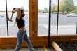 © Mat Hayward - Young girl throws an axe at a target in an axe throwing range