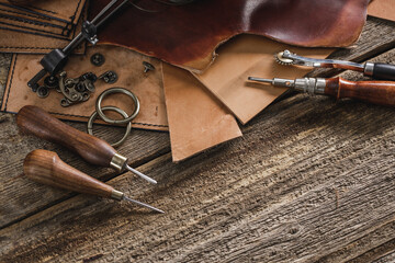 Wall Mural - Leather craft tools on old wood table. Leather craft workshop.