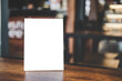 © Freedomz - Mock up acrylic frame posters pattern template forms background, blank menu frame on table in coffee shop stand for your text of display your product