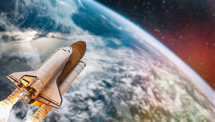 Leinwandbilder - Space shuttle launch in outer space from Earth. Rocket on orbit of the planet. Border of blue sky with clouds and dark deep space. .Elements of this image furnished by NASA 
