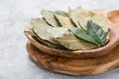 © Maria - Bay leaf or laurel (laurus nobilis), sliced garlic & garlic clove on wooden background