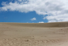 Sand Dunes Background A Blue Cloudy Sky On The Curonian Spit In Lithuania.