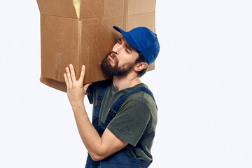 A man in a working uniform with a box in his hands delivery transportation work