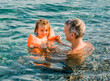 © amelie - Grandfather and toddler girl having fun in sea