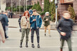 © Svitlana - Full length shot of two teenagers totally absorbed in their smartphones, ignoring each other while standing together on the city street
