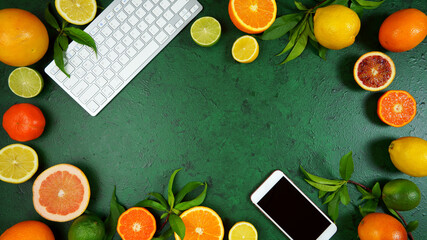 Wall Mural - Health food theme background workspace with citrus fruit on dark green textured background. Top view blog hero header creative composition flat lay with negative copy space.