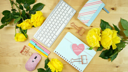 Wall Mural - Modern feminine pink, blue and yellow theme desktop workspace with yellow roses on stylish pale wood background. Top view blog hero header creative composition flat lay.