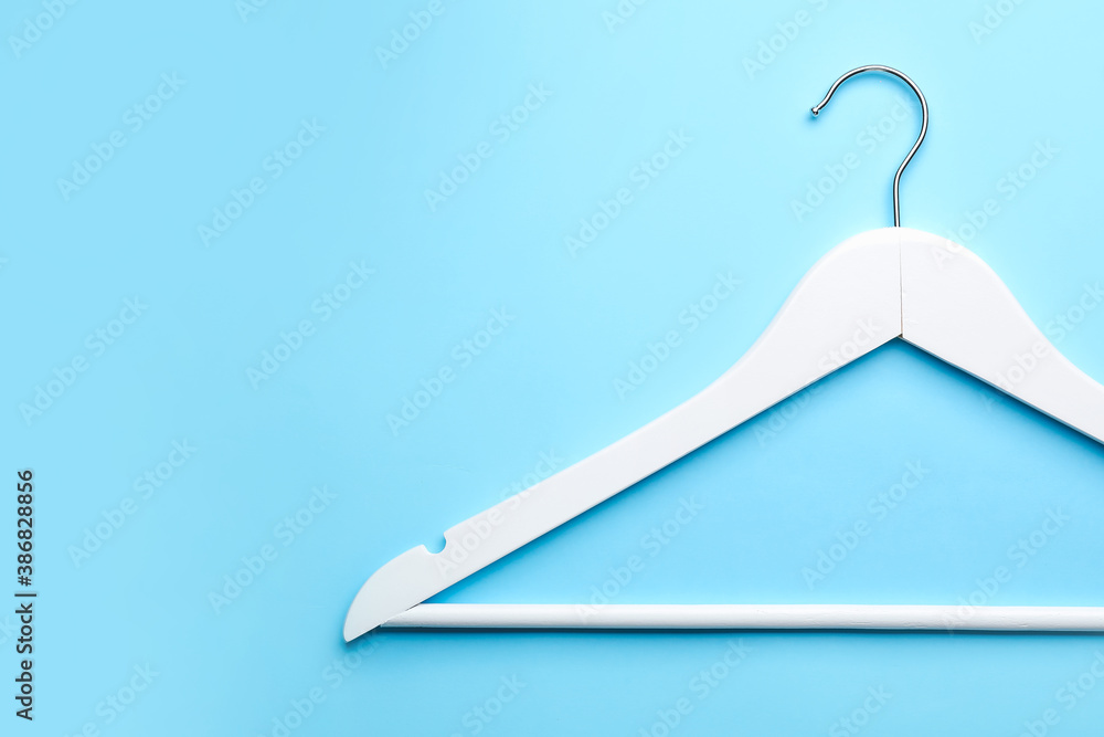 Clothes hanger on color background