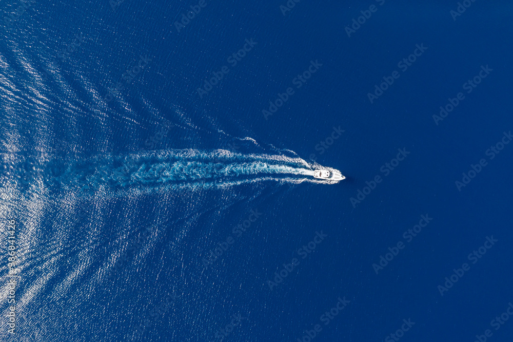 Motorboat and white wake on rippled sea background - obrazy, fototapety, plakaty 