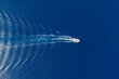 © Rawf8 - Motorboat and white wake on rippled sea background