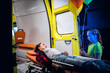© Anna Kosolapova - Little girl standing beside her mother, who is lying on a stretcher next to an ambulance, the woman is trying to calm down her daughter.
