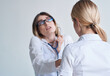 © SHOTPRIME STUDIO - professional woman doctor in medical gown and glasses blue stethoscope patient