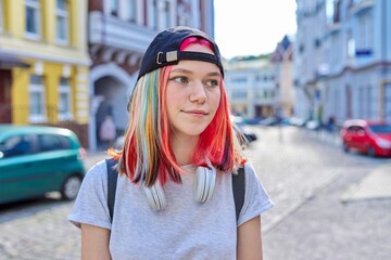 Wall Mural - Portrait of fashionable hipster teenage girl with colored dyed hair in black cap