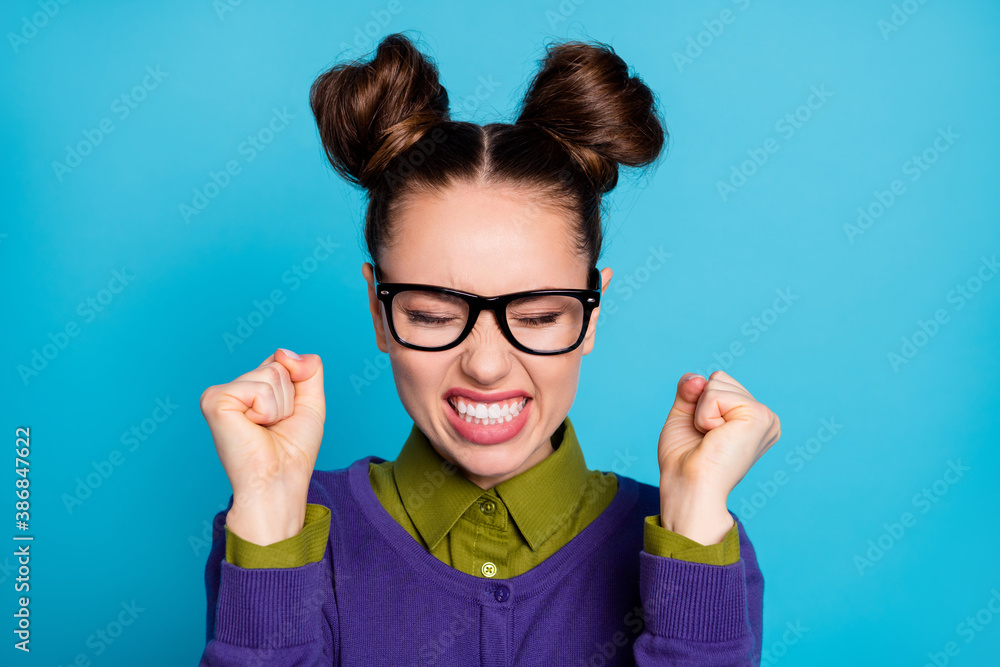 Closeup photo of attractive angry student lady funny buns eyes closed raise fists hate herself made test exam mistake wear specs shirt collar violet sweater isolated blue color background - obrazy, fototapety, plakaty 