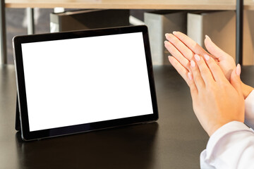 Remote job. Corporate videochat. Successful teamwork. Unrecognizable woman clapping hands tablet computer blank screen wooden table office workplace copy space.