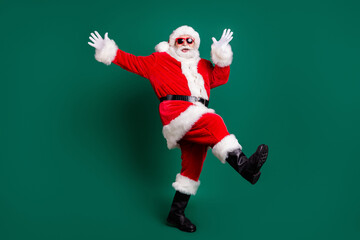 Wall Mural - Full length body size view of his he nice attractive handsome carefree cheerful cheery Santa having fun dancing rest relax amusement celebratory festive day isolated over green color background