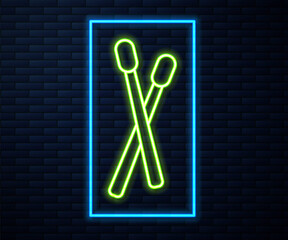 Glowing neon line Drum sticks icon isolated on brick wall background. Musical instrument. Vector.