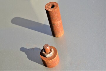 Rusted steel mile and hexagonal nut. Rusted metal exposed to corrosion with thread screw and hexagonal nut. 