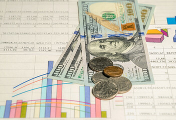 Wall Mural - Economic growth and investment. Dollar bills and charts and graphs of financial indicators