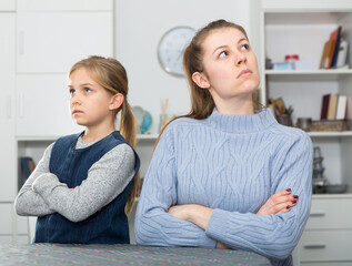 Young woman and her daughter offended at each other after quarrel