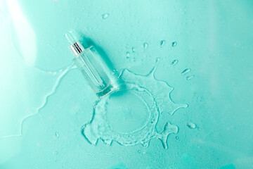 Glass Bottle with fluid collagen and hyaluronic acid, hydration skin. Top flatlay view copyspace. Abstract water background