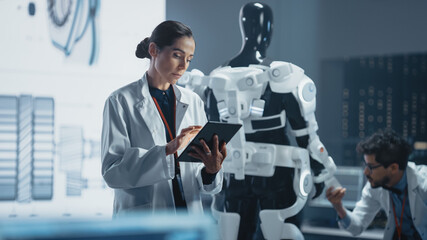 Poster - In Development Laboratory: Portrait of a Beautiful Chief Female Engineer Using Digital Tablet Computer. Scientists Work on Prototype Exoskeleton Designed to Help Disabled People, Hard Labor Workers