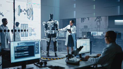 Poster - In Robotics Development Laboratory: Female Scientist Uses Digital Tablet Computer, Work on a Robotics Exoskeleton Prototype. Engineers Designing Exosuit to Help Disabled People, Workers Lift Goods 