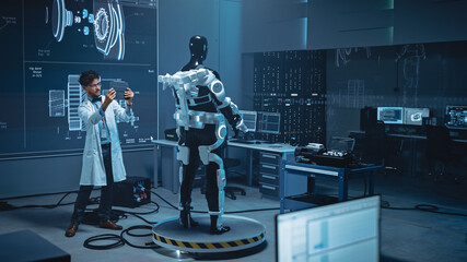 Poster - In Robotics Development Laboratory: Engineer Uses Digital Tablet Computer with Augmented Reality to Design Exoskeleton Prototype. Building Exosuit to Help Disabled People Walk, Workers Lift Goods 