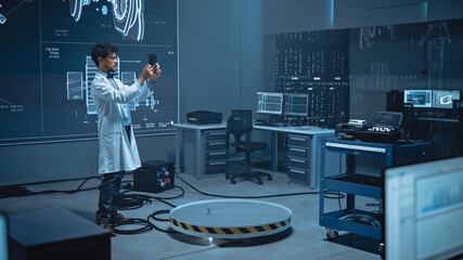 Poster - In High-Tech Development Laboratory: Engineer Uses Digital Tablet Computer with Augmented Reality Software to Analyse Content. Modern Facility with Big Screens Showing Industrial Design.