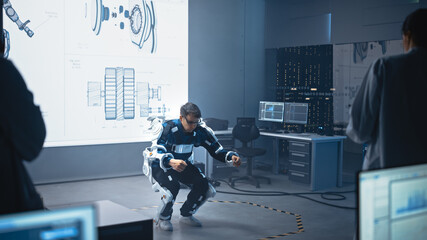 Poster - In Development Laboratory: Engineers and Scientists Look at Robotics Exoskeleton Prototype Presentation with Person Testing it, Doing Sit-ups. Designing Wearable Exosuit to Help People