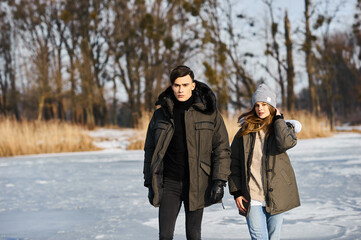 Wall Mural - happy couple hugging and laughing outdoors in winter