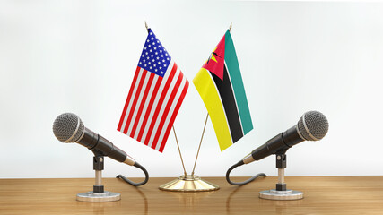 Wall Mural - Microphones and flags pair on a desk over defocused background