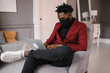 © kalinichenkod - a black man works at a laptop close-up of his face. video conferences man wearing medical mask