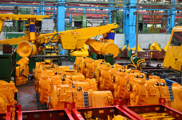 Production process of heavy mining trucks at the factory. Dump truck on the Industrial conveyor in the workshop of an automobile plant. Manufacturer of haulage and earthmoving equipment, haul trucksм