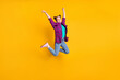 © deagreez - Full length photo of attractive crazy teen lady jump high up air flight ecstatic champion marathon sports competition wear casual plaid shirt shoes jeans isolated yellow color background