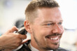 © Тихон Купревич - Smiling man who has haircut at barbershop. Courses and training for hairdressers concept