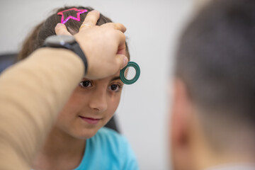 Poster - Young girl visited by ophthalmologist