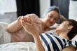 © gpointstudio - Close up of lesbian couple holding hands in the bed